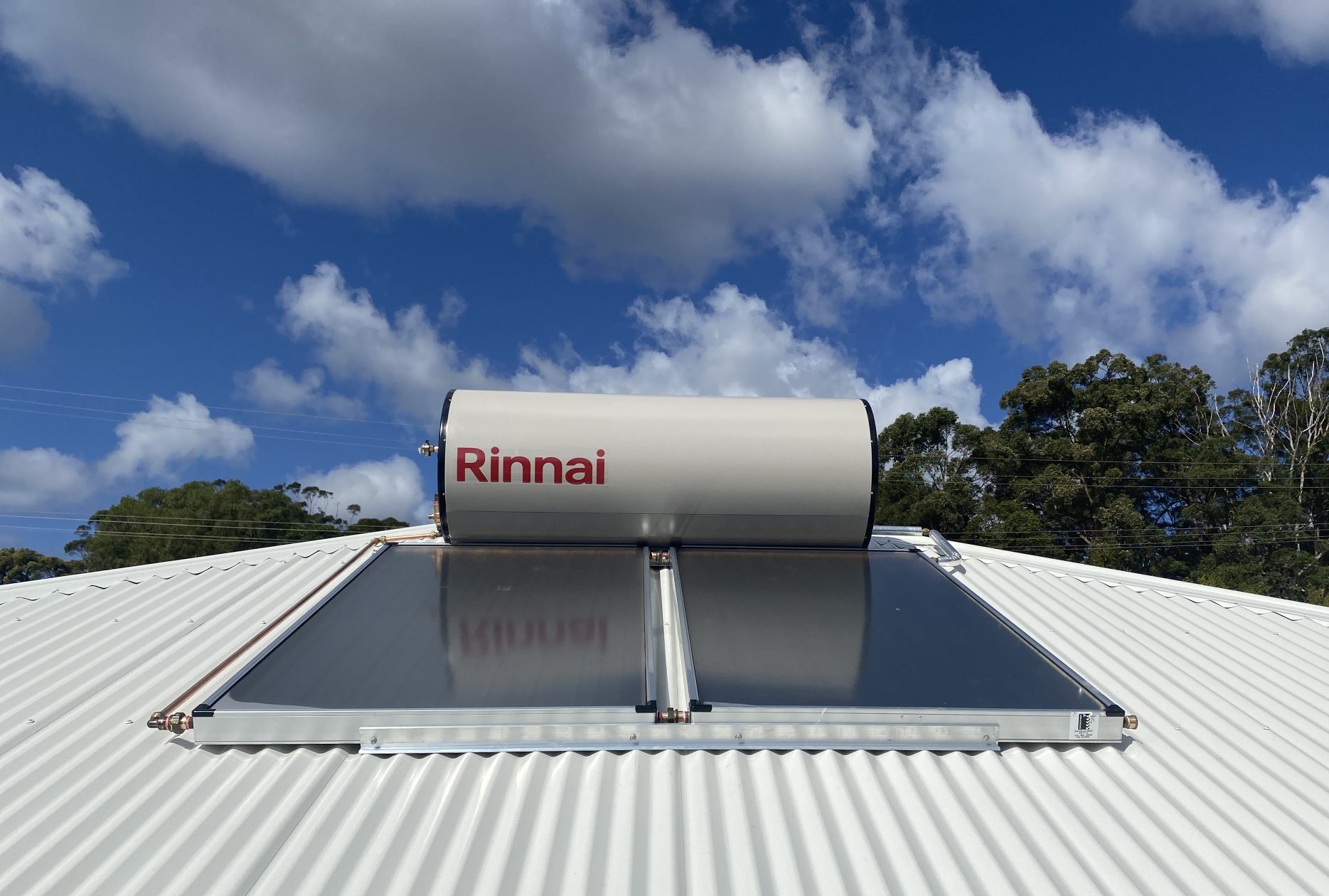 Rinnai solar hot water system getting craned onto roof for new build